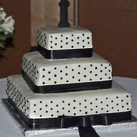 Black And White Cake The bride wanted this cake to be elegant and chose not to have flowers on it, but there was a bouquet on the table next to the cake. There...