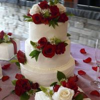Tiered White Cake With Red Roses this cake is very plain with red and white roses-there are three smaller square cakes with it that are meant to look like gift packages