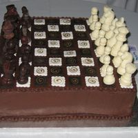 Ricky Chocolate buttercrean with fondant decoration for the board and chocolate chess figures! sorry I'm not sure what you call them!