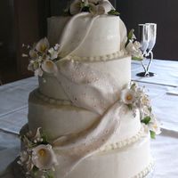 Sarah 4 tier covered in buttercream with fondant drapes and calla lilies