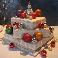 Santa Wedding This cake was decorated with ivory fondant, with diamond impressions. The trimmings are made out of fondant and hand painted with gold...