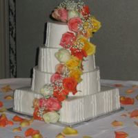 Caribe Square and round cakes with buttercream frosting and natural colored roses, and oriental buttercream design.