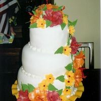 Mom's 50Th HibiscusI got my inspiration for this cake from Fred's Bakery's web-site. The Hibiscus flowers are Fondant.