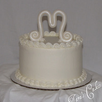 Simply M Just a quick cake for a friend.....buttercream with a "M" made of fondant, fondant flowers