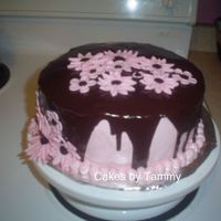 Birthday Cake For Nan WASC covered with IMBC and drizzled with chocolate ganache. Fondany daisies. Inspired by Dollycakes.