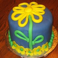 Yellow Flower This is a going away cake for a co-worker. I had completely different plans for the cake. Once I got it covered with the blue fondant, I...