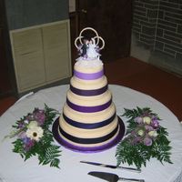 Wedding Cake W/ribbon Cake is yellow with strawberry filling, buttercream icing and then covered in ivory MMF. Ribbon is fabric. This is only the second wedding...