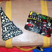 France Cake for couple beginning ministry in France. Top pieces are chocolate transfers. Buttercream icing with fondant accents.