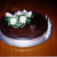 60Th Birthday Cake Once again, another mud cake covered in ganache with small fretwork chocolate lace around the entire top.Fresh pink rose on top. Thanks for...