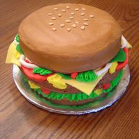 Cheeseburger Cake Three-layer, 10" round cakes with fondant "cheese," "pickles," and "sesame seeds" and everything else...
