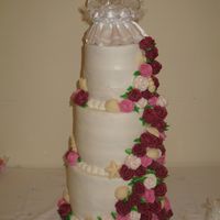 Adrianne 3 tier (3, 2" layers each tier) with buttercream filling/frosting. Covered with a buttercream rose cascade and white chocolate...