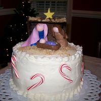 Jesus Birthday Cake With Candy Canes 2 layer 8 inch white cake iced with crusting cream cheese icing and fondant nativity scene; crushed mini wheat cereal for straw; candy...