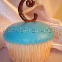 Monogram Cupcakes This was one of two dozen monogram cupcakes for a baby shower! WASC cake with poured fondant and chocolate monograms! Pretty easy to make,...