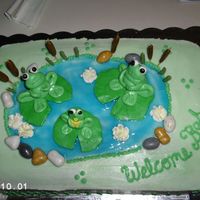 Frog-Themed Shower Cake This is my first attempt at fondant. The frogs, lily pads and cattails are fondant. The water is piping gel and the rocks are hard candy.