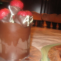 Chocolate Wrapped Kahlua Cake With Choccolate Dipped Strawberrie ths is a chocolate wrapped kahlua cake with chocolate dipped strawberries.