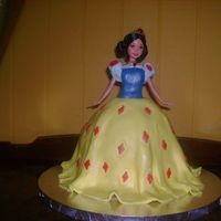 Snow White Doll Cake This cake is white cake for the skirt part and yellow cake for the 9 inch round layer underneath to give it more height because the doll is...