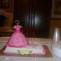 Granddaughter's 5 Year Old Birthday Cake The bottom cake is strawberry with buttercream icing and gumpaste flowers. The doll cake is chocolate cake with mmf covering her bodice and...