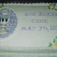 Grandaughter's 1St Communion White cake with buttercream frosting. Chalice and oval backgroud is made of molded white chocolate