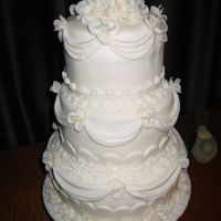 Sweet Memories Cream fondant cover cakes with drapes made from molds and hand gathered. Gumpaste/fondant wild rose flowers and muliple small flowers on...