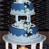 True Blue Lov 3 Tiers of blue fondant covered heart shaped cakes. Decorations include over 60 white roses, navy orchids, light blue for-grt-mr-nots, and...