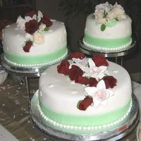 Shelly's Shower Cake Made to match the bride's and bridesmaid flowers. White fondant with light sage green fondant ribbon ( bridemaid's dress colour...