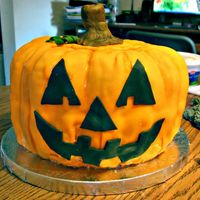 Pumpkin two bundt cakes, covered with fondant and fondant decorations.
