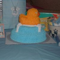 2006_0716Puppies7-12-060105.jpg Rubber ducky shower cake. Sorry... last minute and forgot to put something under the cake other than the board. hee hee