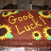 Good Luck! Chocolate cake with chocolate BC icing. Sunflowers are also made out of BC icing.