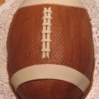 First Football Cake... I had trouble getting the icing the color I wanted...I finally used melted dark chocolate chips along with brown coloring. So it is OK for...