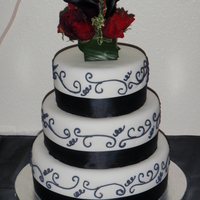 Simple Elegance This is a simple yet elegant wedding cake I was asked to do. All tiers are covered in fondant, with royal icing scroll work, satin ribbon...