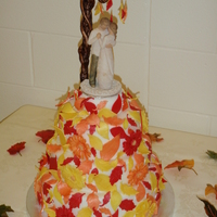 Fall Florals This colourful fall wedding cake is covered in fondant, gum paste leaves and daisy's all covered in luster dust. Thanks for looking!