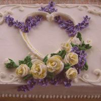 Victorian Valentine Sheet cake iced and decorated with buttercream. Overpiped heart. Buttercream roses and violets.