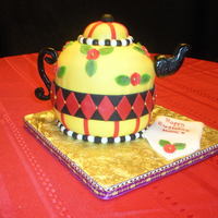 Mary Englebright Tea Pot Cake Made from wilton ball pan and a 6" round in the middle covered in MFF, handle and spout is gumpaste. Napkin is fondant.