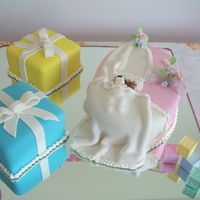 Baby Crib This cake was inspired in one I saw in the web. Oval Cake with two 6" square pans. The baby is made of gumpaste.