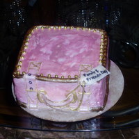 Pink Suitcase 6x6x4 Yellow cake cover in rolled fondant. Painted pink and gold with edible gold balls.