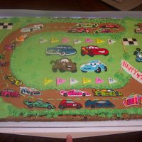 Decorated Cookie I didn't make the cookie -- only decorated it. Race cars & Cars Characters are RI with painted accents; flags & banners are...