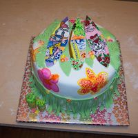 Hawaiian Surfer covered in fondant with painted flowers and fondant grass skirt (thank you to the person on cake central that originally made a grass skirt...