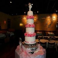 My Daughter's Wedding Cake Cake is 12, 10, 8 and 6 covered in Satin ice. I made all the roses out of Nick Lodge gumpaste.