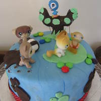 Littlest Pet Shop A chocolate cake covered in fondant. This was my 8 year old daughters first decorating attempt for her birthday- with a little help from...