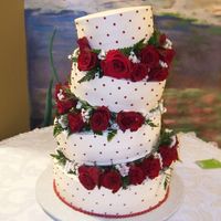 Tilted Red Roses Cake This cake is made with whipped cream in ivory and it has Black Magic Roses in between tiers. The family loved it so much that they took a...