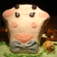 Wyatt James WSCA cake with buttercream, the fence is gingerbread and the sign post and cow face and spots are fondant.