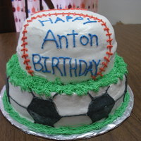 Soccer And Baseball Cake Tiered cake. 10" and 8" layers. Buttercream frosting.