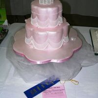 P1080703.jpg 6 and 9 petal dummies on a 16" board covered with pink fondant then brush painted with superpearl. Gumpaste floating collar. Bridges...