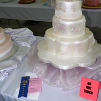 2008 Mid-Atlantic Cake Show Intermediate Division - Best Of Division Winner 6, 9, 12" round and petal dummies on a 18" petal board. All covered with wilton white fondant and then brush painted with super...