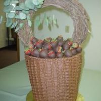 Basket Of Chocolate Covered Strawberries 3-tier chocolate cake carved and frosted in basketweave, topped with a grapevine handle and chocolate covered strawberries.