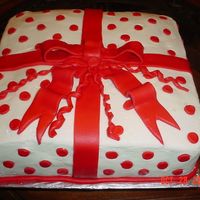 Present Cake Three layers with Buttercream Icing. Bow & dots are MMF.