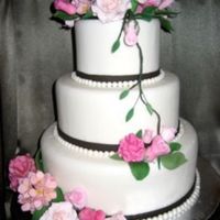 Pink Wedding Cake Fair entry. Covered in fondant. Gumpaste flowers. This was my first time making flowers, pearls, ribbon and covering a cake with fondant. I...