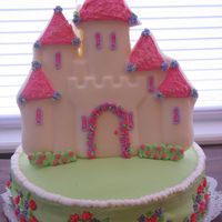 1St Birthday Princess Castle Cake This is a Princess Castle cake for my neice's First Birthday. The castle is made out of white chocolate using the Wilton Castle cake...