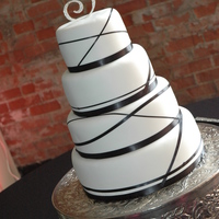 Black Ribbon Fondant covered - with black ribbon wrapped around it. Topper was "jeweled". I liked the way it turned out!