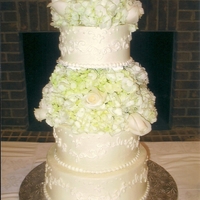 Ivory And White All buttercream tinted in a light ivory with white scroll work. The floral was real-white hydrangias and white roses